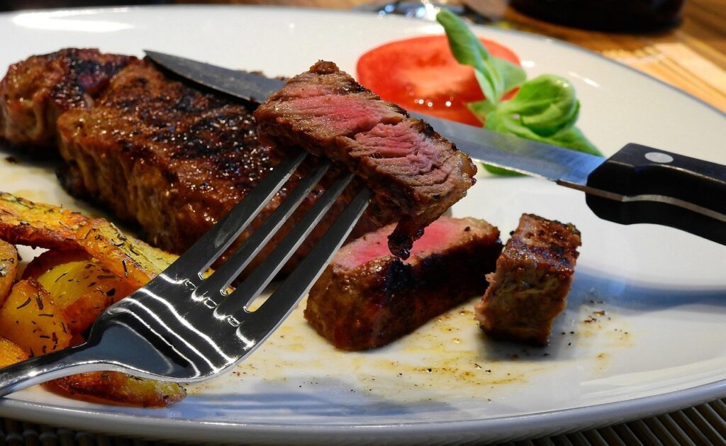 air fired steak on a plate with herbed potatoes